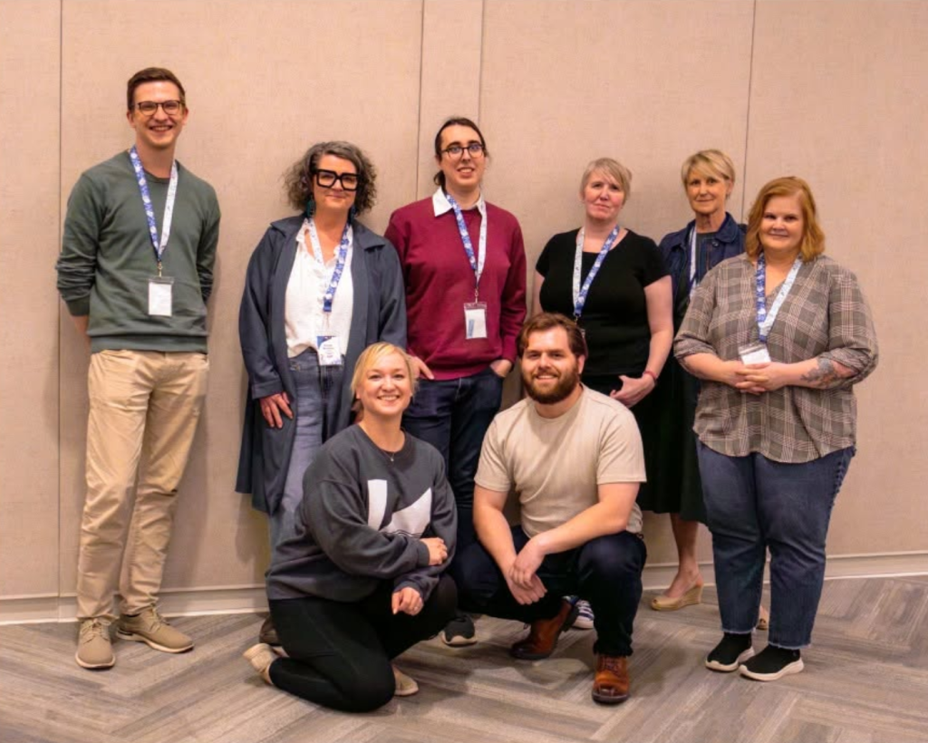 A group of eight people from the Manitoba Libraries Conference 2025 Planning Committee.